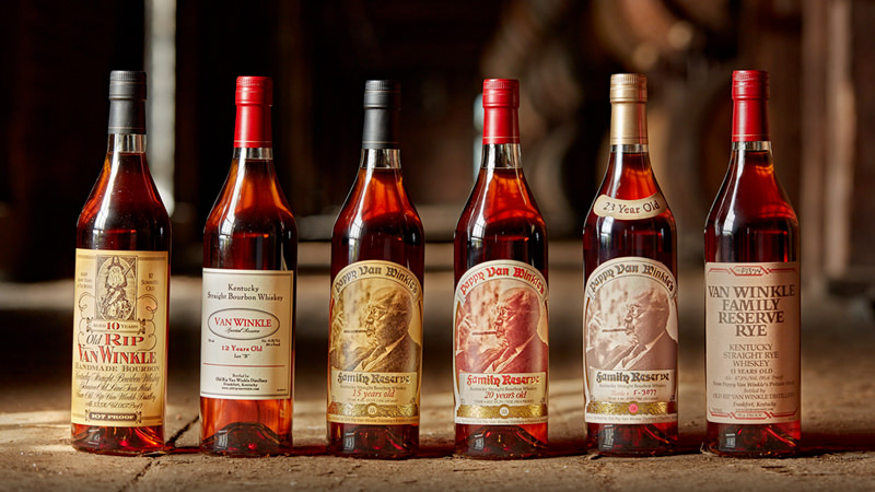 row of pappy van winkle bourbon bottles with a blurry background