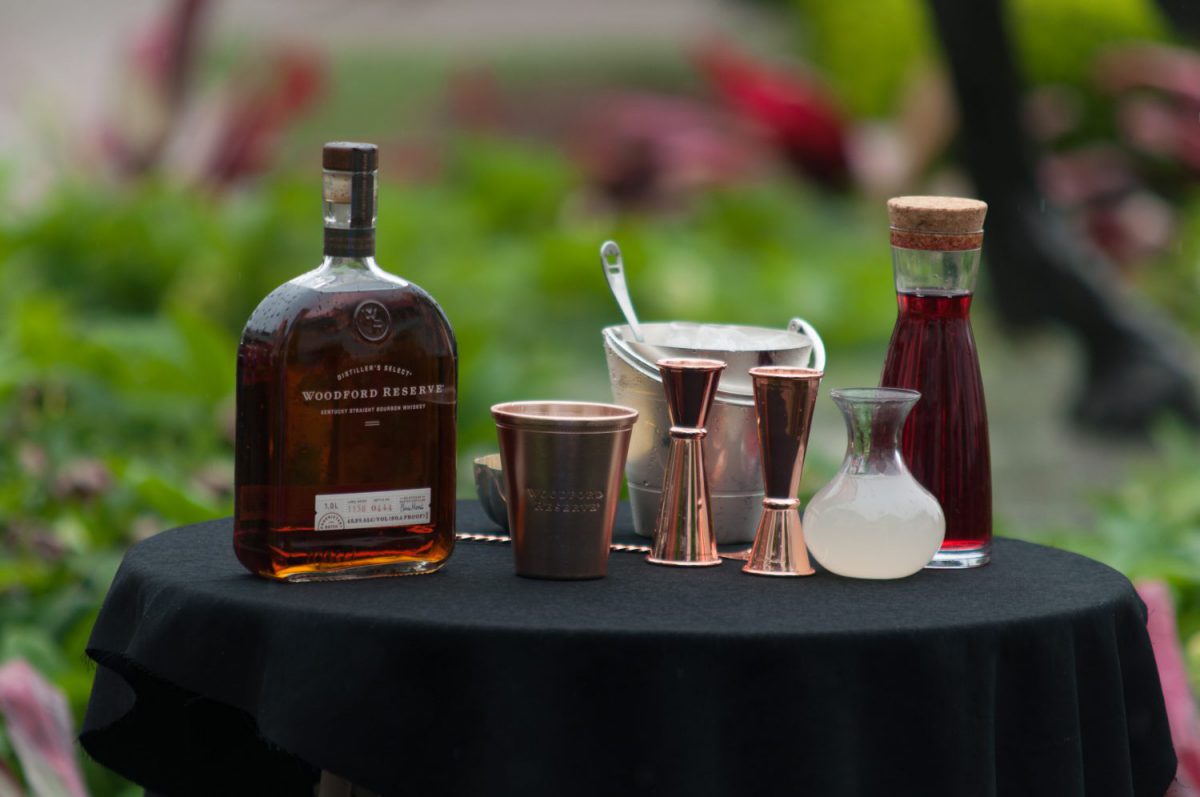 Kentucky Derby: woodford reserve bottle and cocktail tools on a table with a black table cloth