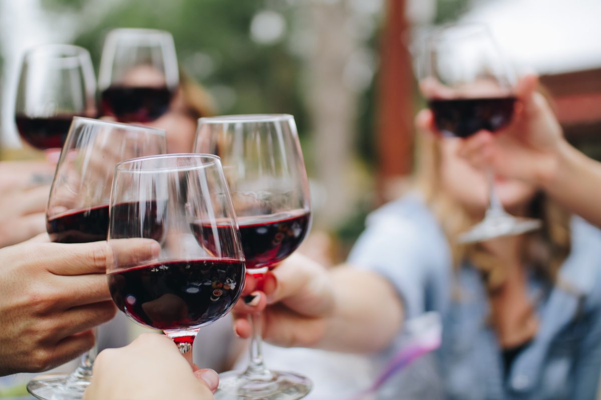 Women's History Month: group of people holding glasses filled with red wine