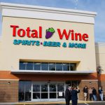 A building that says Total Wine with a line out the door