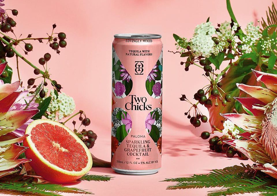 Sparkling Cocktail: a pink can with a grapefruit and flowers surrounding it and a pink background