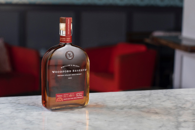 Whiskey: bottle of a dark liquid on a marble bar
