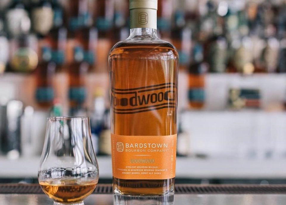 goodwood brewing: bourbon bottle and glass on a bar