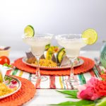 Margaritas and Mexican food on colorful tabletop